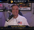 Man in a studio with a microphone and headphones, featuring the 4Liberty Network logo.