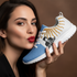 Argentine model with red lips kissing Javier Milei Afuera sneakers