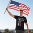 Patriotic man with American flag wearing Liberty Nation shirt