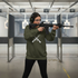 Woman at firing range wearing Crossed Rifles crewneck - full view